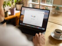 person using macbook pro on table